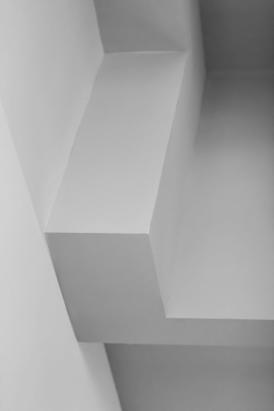 a white staircase with a white railing